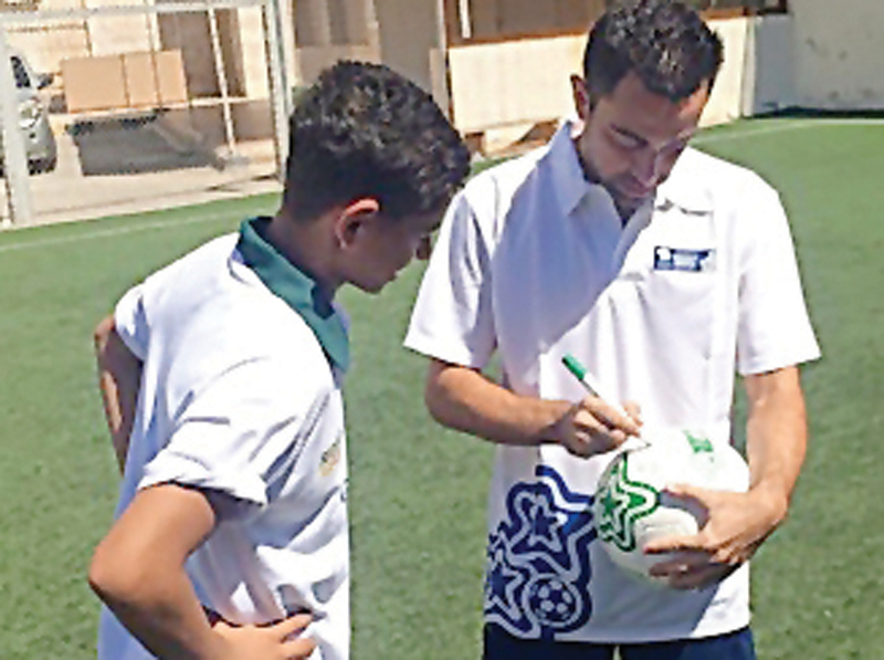 Supreme Committee for Delivery and Legacy’s (SC) Generation Amazing ambassador Xavi (right) signs an autograph during the practice session. 