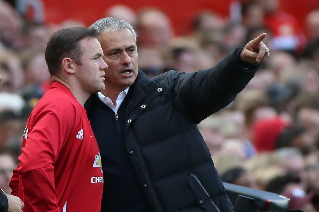 Manchester United's Portuguese manager Jose Mourinho (R) gives instructions to Manchester United's English striker Wayne Rooney as he comes on as a substitute during the English Premier League football match between Manchester United and Stoke City at Old