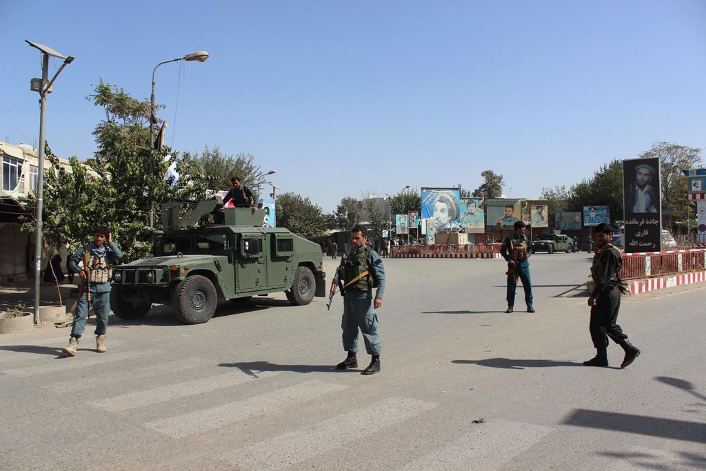 Afghan policeman stand alert during fighting between Taliban militants and Afghan security forces in Kunduz on October 3, 2016. AFP / BASHIR KHAN SAFI