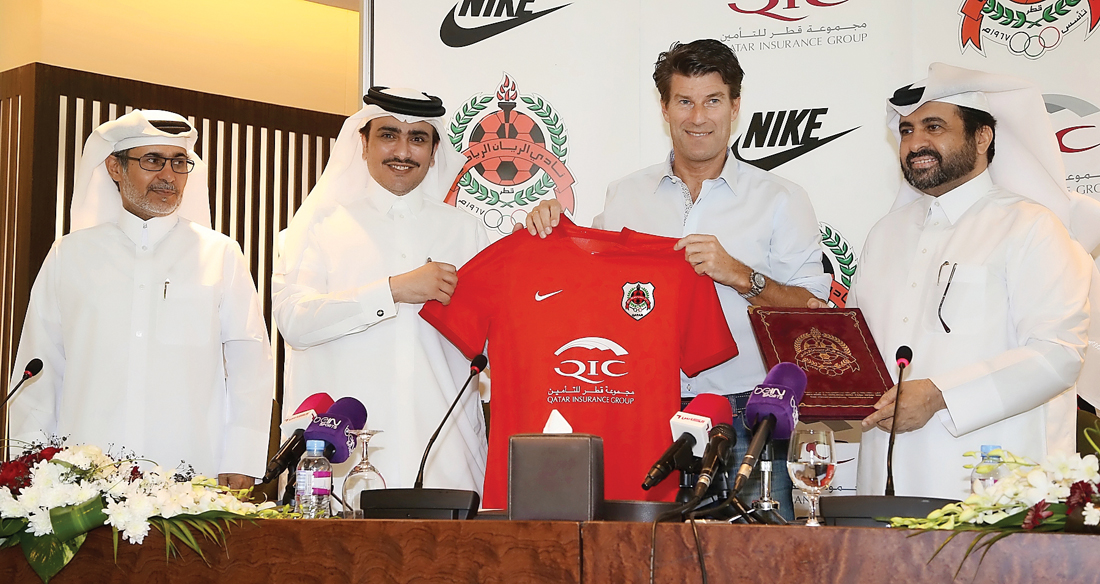 Al Rayyan Sports Club Chairman Sheikh Saoud bin Khalid Al Thani presents a team jersey to their new coach Michael Laudrup during a press briefing held yesterday. Pictures by: Hussein Sayed  