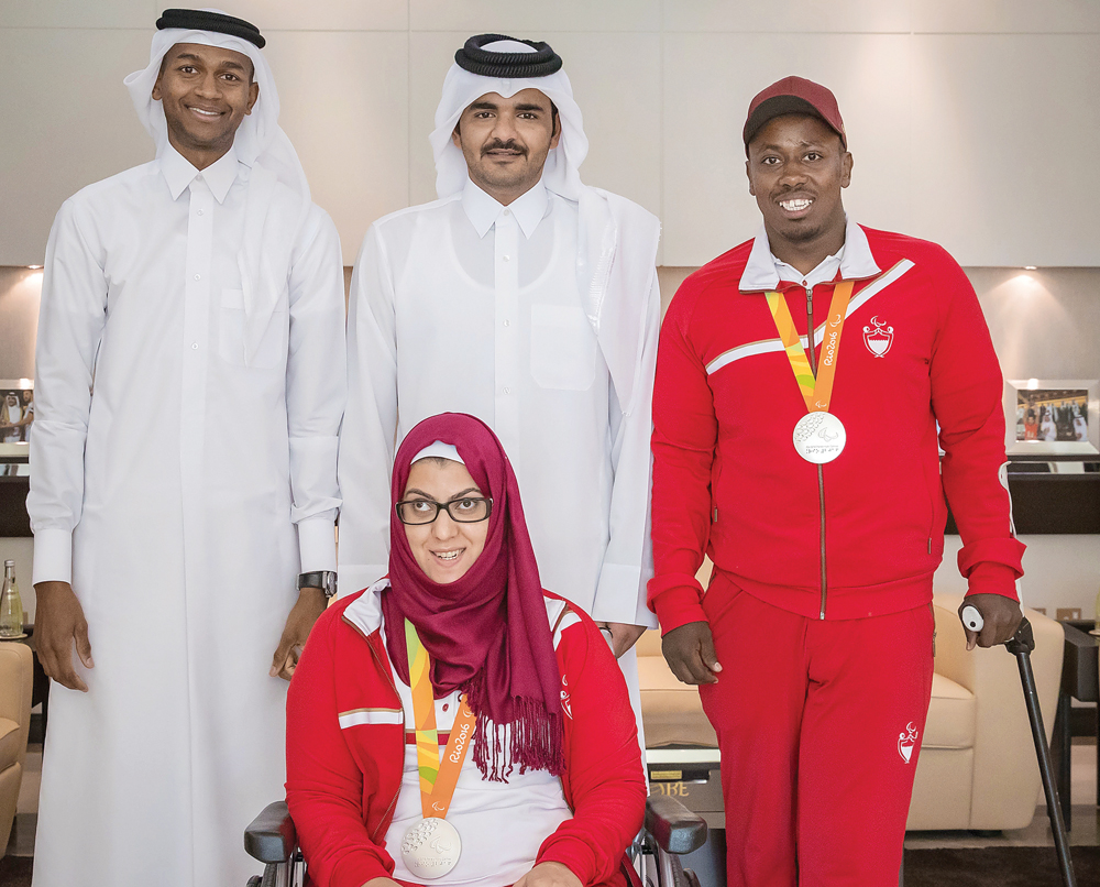 Qatar Olympic Committee President Sheikh Joaan bin Hamad Al Thani poses for a photograph with Rio 2016 Olympic silver medallist Mutaz Essa Barshim (left) and Paralympic silver medallists Abdelrahman Abdelqader (right) and Sara Masoud at the QOC headquarte