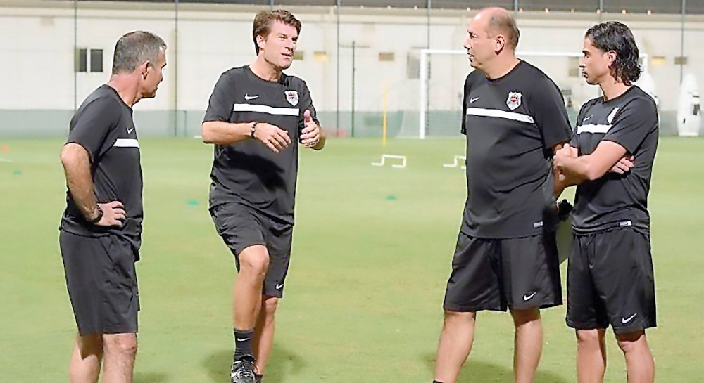 Al Rayyan’s new head coach Michael Laudrup (second left) speaks with supporting staff during a training session.
