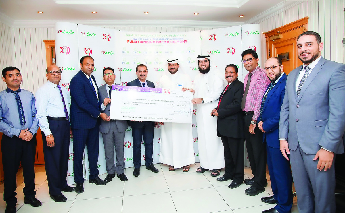 Officials from Lulu Hypermarket handing over a cheque of QR275,000 to RAF officials in a ceremony at Lulu D-Ring Road branch.