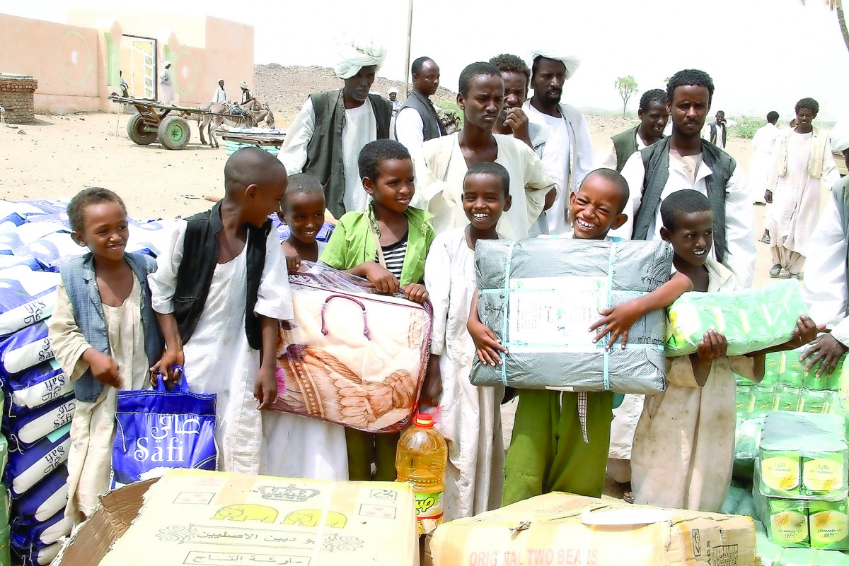 Residents of eastern Sudan receiving aid packets from Qatar Charity officials.