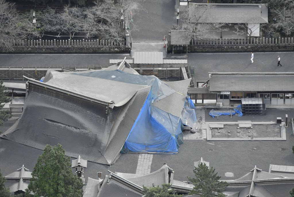 The collapsed buildings of Aso Shrine which were damaged by last April's earthquake are covered with volcanic ashes from Mount Aso in Aso, Kumamoto prefecture, southwestern Japan, in this photo taken by Kyodo October 8, 2016. Kyodo via Reuters