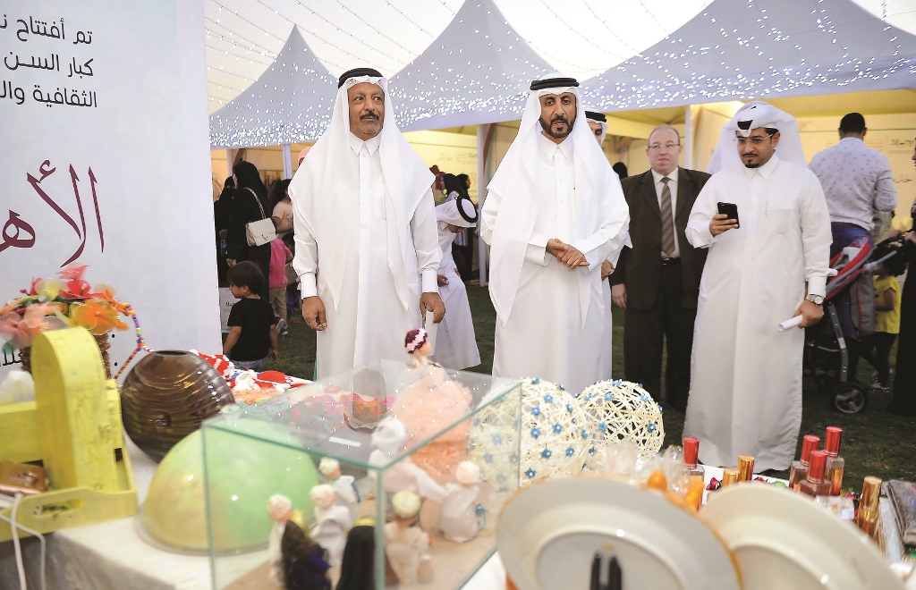 Mubarak bin Abdul-Aziz Al Khalifa, CEO of Qatar Foundation for Elderly People Care (Ihsan), taking a tour of stalls with other officials during the celebration of World Day for Elderly at Aspire Park yesterday. Abdul Basit / The Peninsula