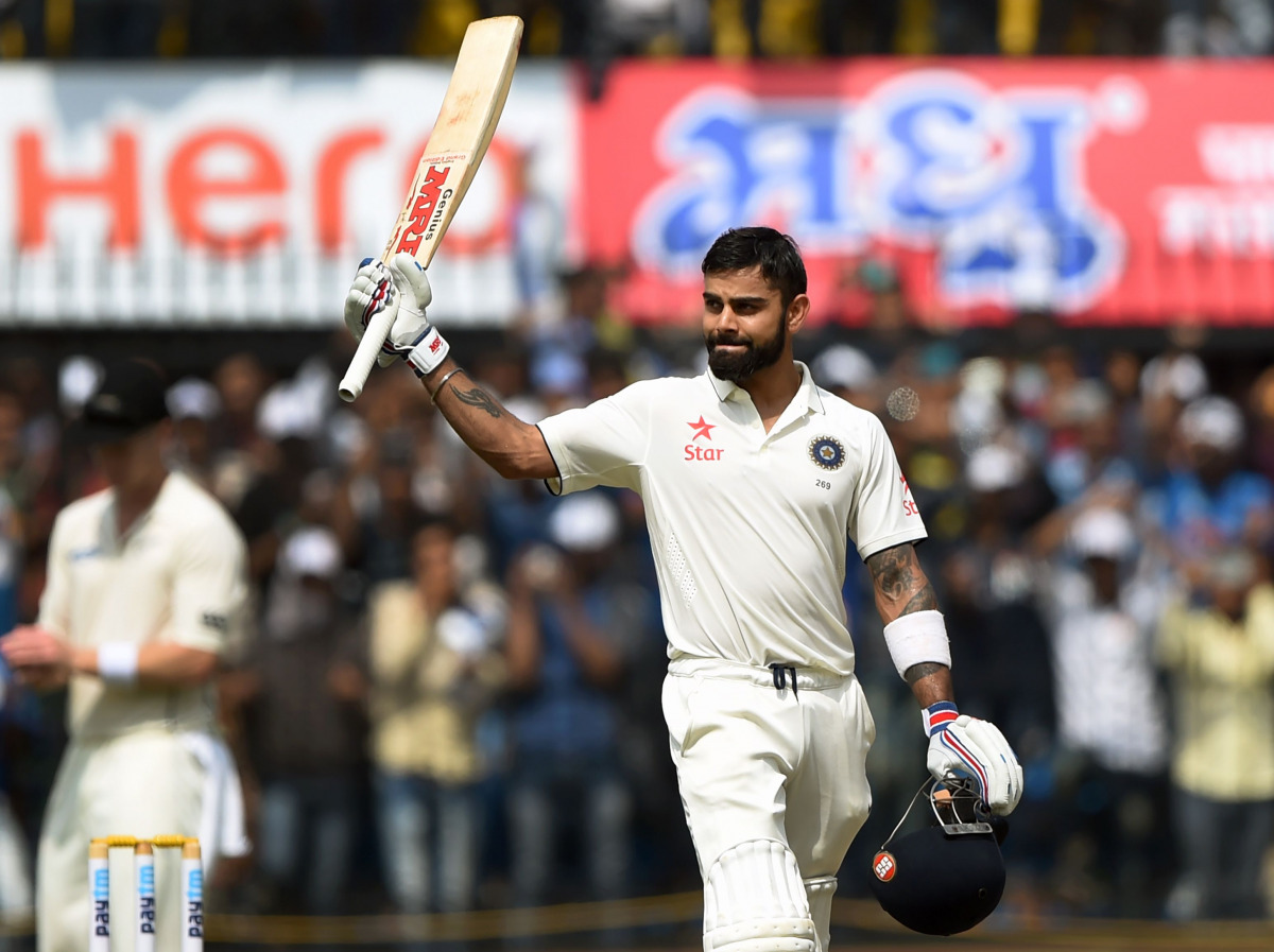 India's batsman and captain Virat Kohli celebrates after scoring a double century during the second day of third test cricket match between India and New Zealand at The Holkar Cricket Stadium in Indore on October 9, 2016. (AFP / PUNIT PARANJPE)