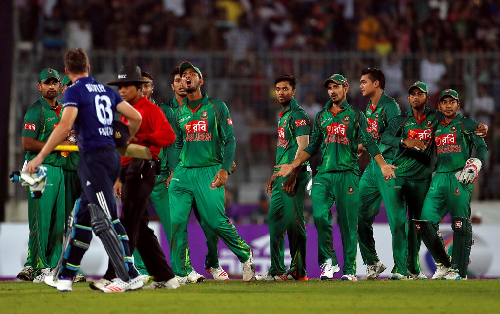 Bangladesh players exchange words with England's Jos Buttler after he was bowled out during the second One Day International. (Reuters/Cathal McNaughton)