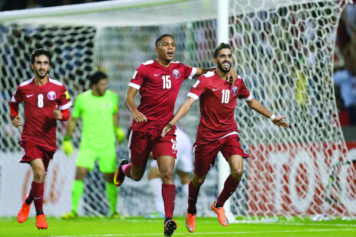 Qatar’s Hassan Al Haydos (right) celebrates after scoring a penalty during their 2018 World Cup qualifying football match against Syria at the Jassim Bin Hamad Stadium in Doha yesterday.
