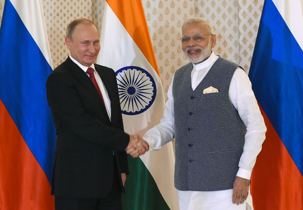 Indian Prime Minister Narendra Modi (R) shakes hands with Russian President Vladimir Putin ahead of the Indo-Russia Annual Summit at Taj Exotica Hotel in Goa. AFP/Prakash Singh