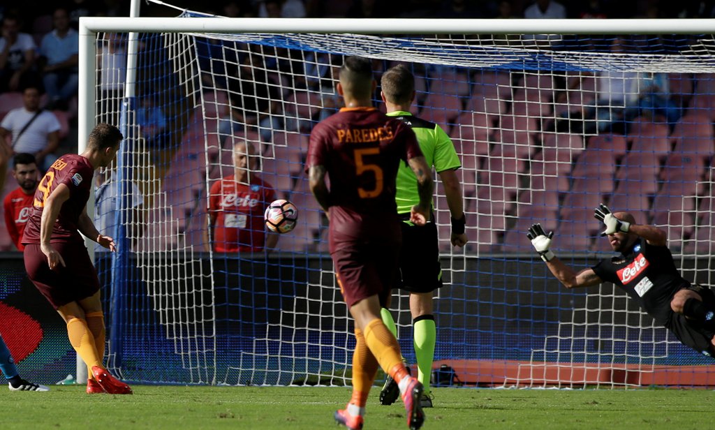 AS Roma's Edin Dzeko (L) shoots to score. REUTERS/Max Rossi
