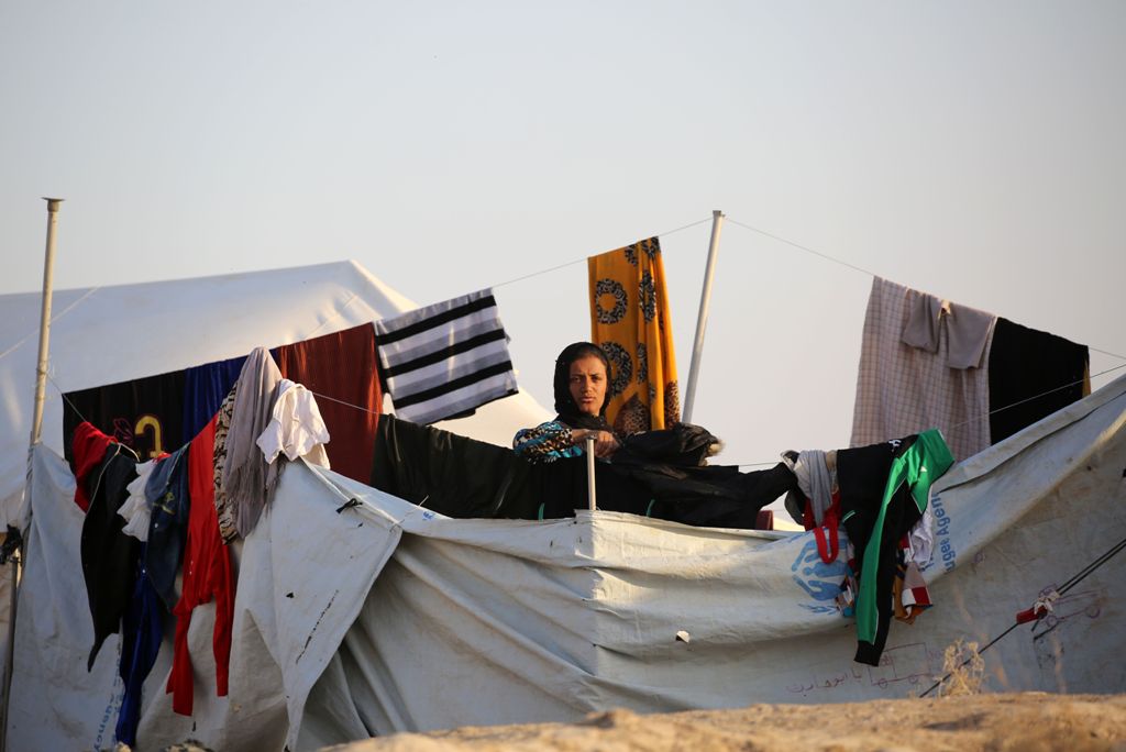 A woman poses at a refugee camp housing Iraqi families who fled fighting in the Mosul area on October 17, 2016 in the northeastern town of al-Hol in Syria's Hasakeh province. The battle to retake the Iraqi city of Mosul from jihadists could unleash a mass