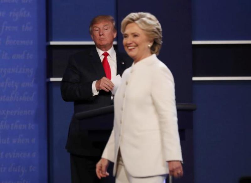 Republican U.S. presidential nominee Donald Trump and Democratic U.S. presidential nominee Hillary Clinton finish their third and final 2016 presidential campaign debate at UNLV in Las Vegas, Nevada, U.S., October 19, 2016. REUTERS/Mike Blake