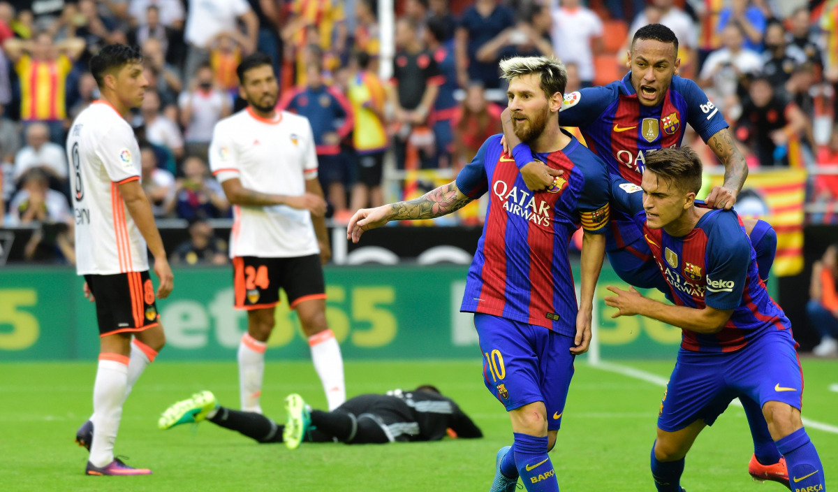 Barcelona's Argentinian forward Lionel Messi (C) celebrates with Barcelona's Brazilian forward Neymar (2ndR) and Barcelona's midfielder Denis Suarez (R) after scoring during the Spanish league football match Valencia CF vs FC Barcelona at the Mestalla sta