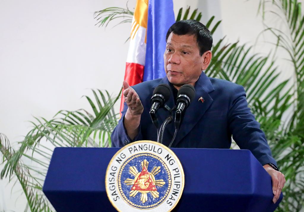 Philippine President Rodrigo Duterte gestures as he speaks at the Davao International Airport after arriving back from a state visit to Brunei and China on October 22, 2016. AFP / Manman Dejeto 