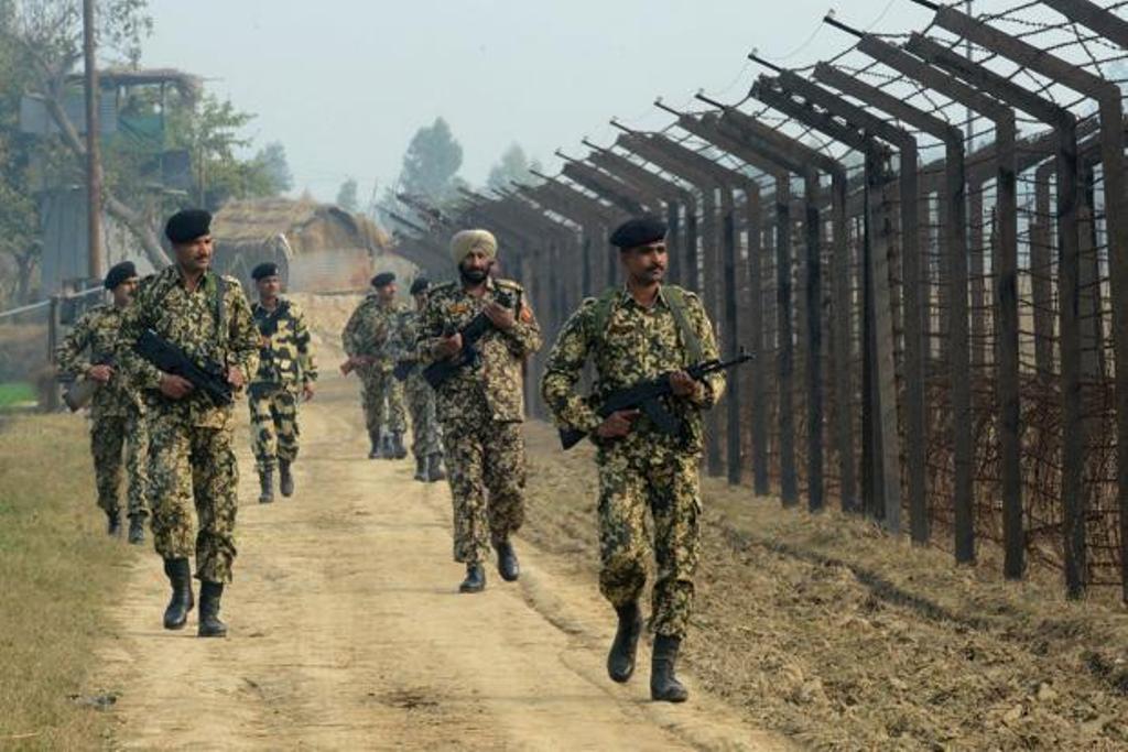 A file photo of Indian Border Security Force soldiers patrolling along the India-Pakistan border fence about 27km from Wagah. Photo: AFP.