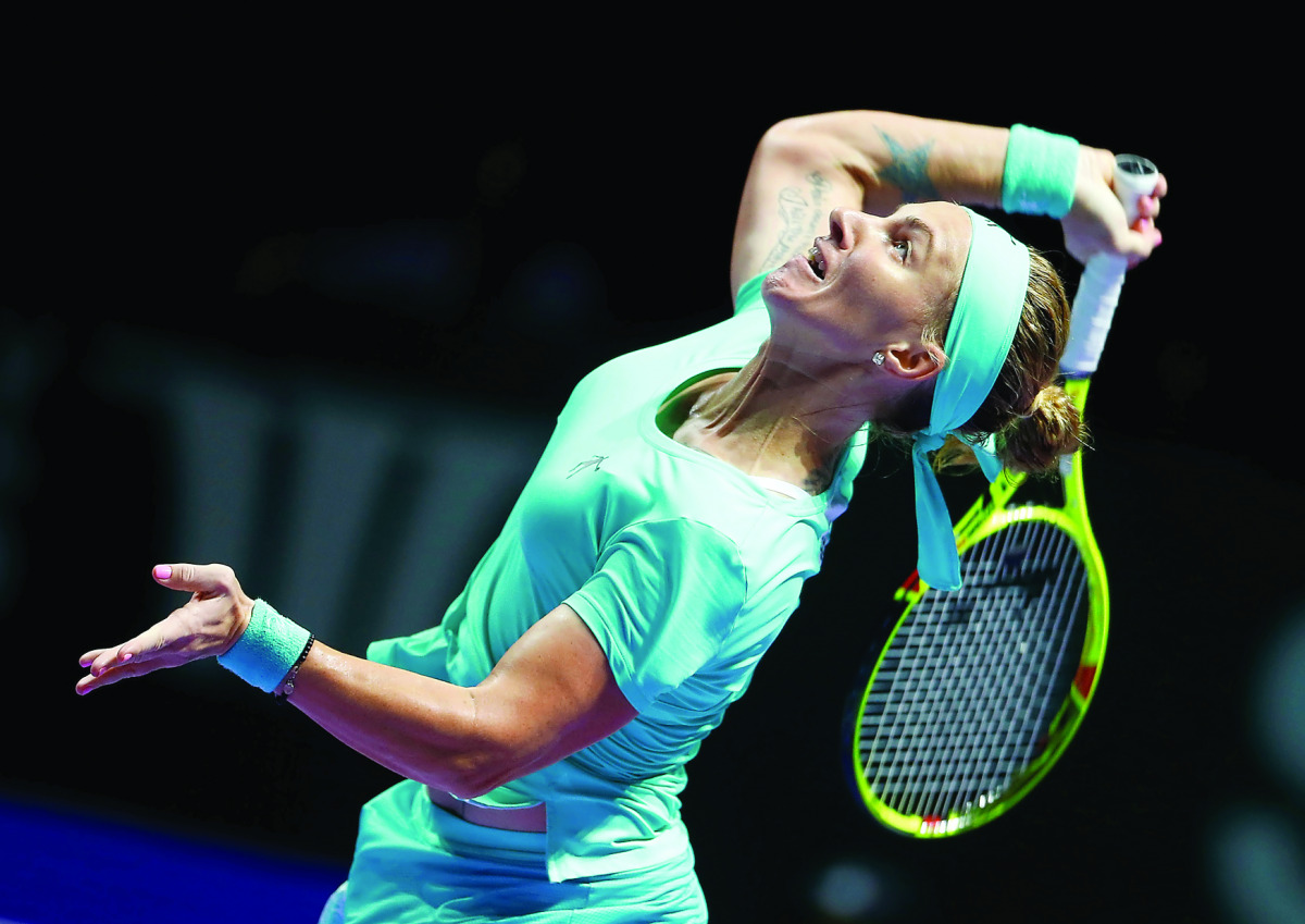 Svetlana Kuznetsova of Russia in action against Agnieszka Radwanska of  Poland during their match in the Singapore WTA  Finals Round Robin Singles, at the National Indoor Stadium, in Singapore, yesterday.
