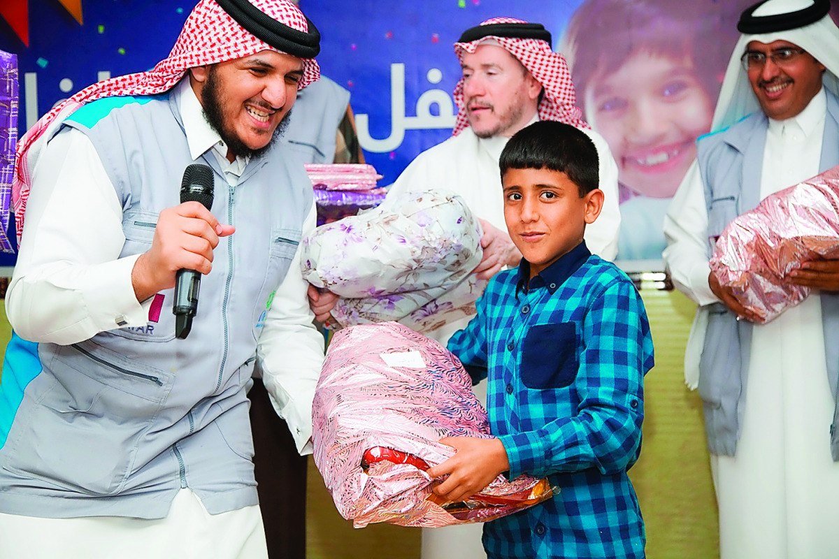 A Syrian child receiving gifts from RAF officials.