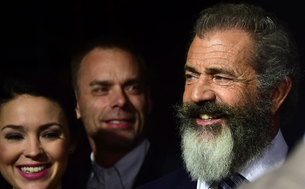 Mel Gibson (R), actor-turned-director for this film, smiles on arrival for the Los Angeles special screening of 'Hacksaw Ridge' at the Samuel Goldwyn Theater in Beverly Hills, California on October 24, 2016. AFP / Frederic J. BROWN