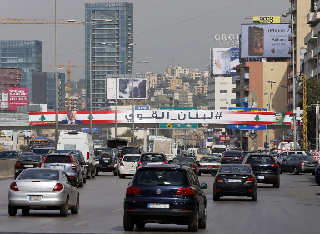 A giant poster that reads 'Strong Lebanon' and bears the portrait of Lebanese presidential candidate Michel Aoun is seen on a bridge on the Zalka highway, north of the capital Beirut on October 28, 2016.  AFP / JOSEPH EID