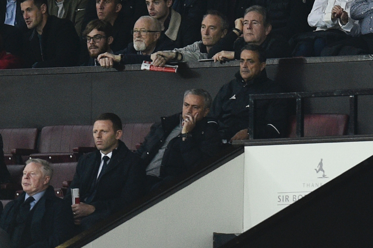 Manchester United's Portuguese manager Jose Mourinho (C) sits in the Directors Box with spectators after being sent off from the pitchside during the English Premier League football match between Manchester United and Burnley at Old Trafford in Manchester