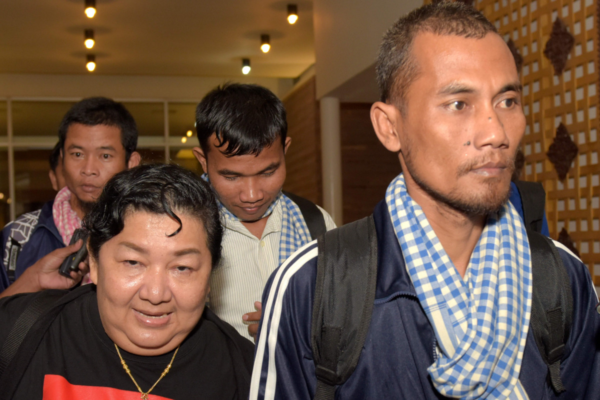 Cambodian seafarers released after being held hostage by Somali pirates are surrounded by media after arriving at Phnom Penh International Airport on October 30, 2016. The seafarers are among 26 hostages freed from the crew of Naham 3 seized south of the 
