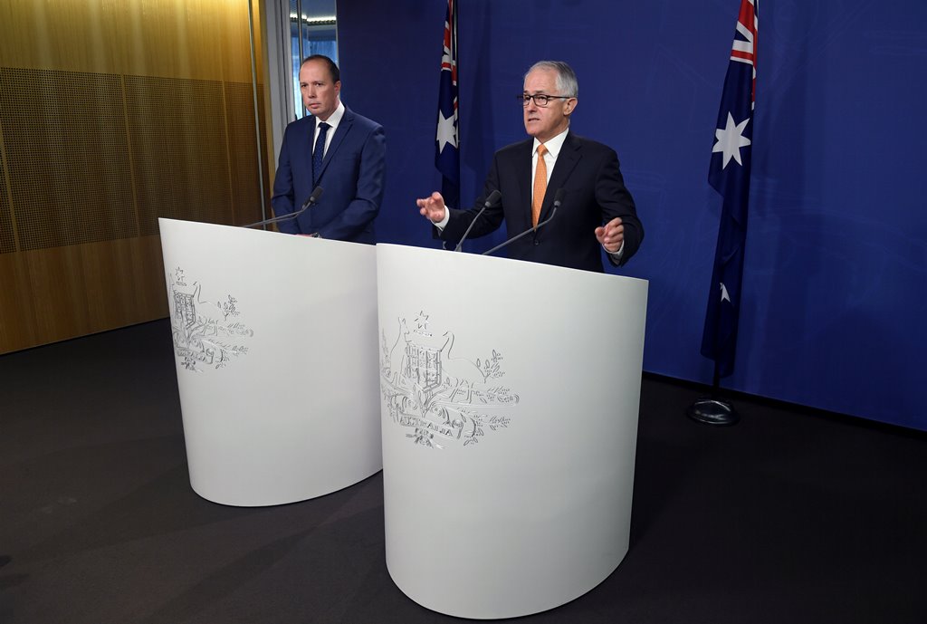 Australian Prime Minister Malcolm Turnbull (R) speaks as he stands with Immigration Minister Peter Dutton during a media conference in Sydney, Australia, October 30, 2016. AAP/Paul Miller/via REUTERS