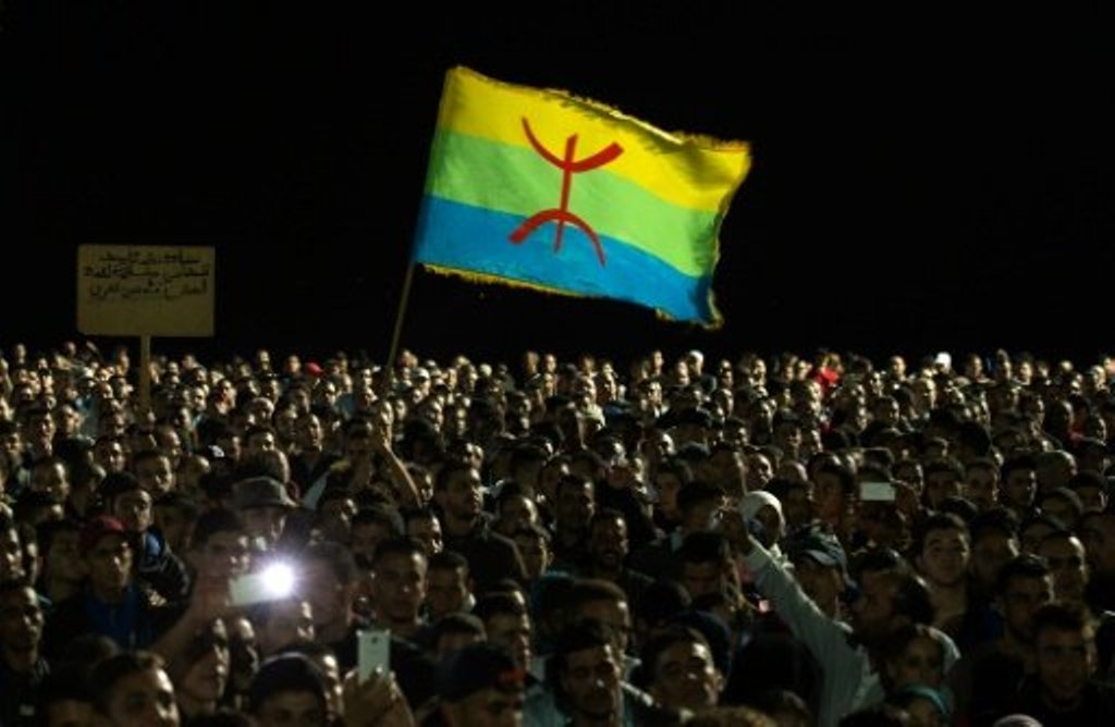 © AFP/File | Protesters hold the Amazigh (Berber) flag during a demonstration in the northern Moroccan city of Al Hoceima on October 30, 2016, following the death of fish seller Mouhcine Fikri