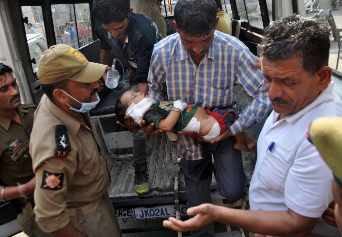 Indian volunteers and officials carry a two and a half year-old child Pari into The Government Medical College Hospital in Jammu on November 1, 2016, after he was injured in cross-border shelling in the disputed Himalayan region of Kashmir. Indian authori