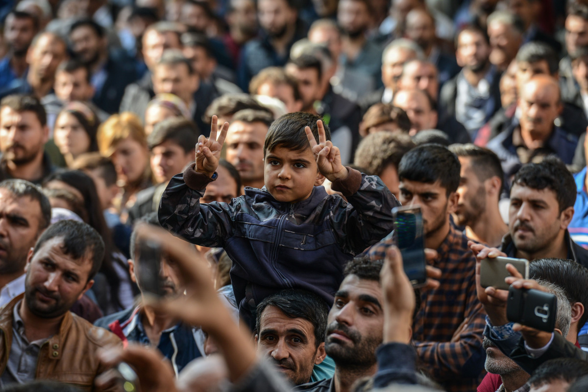 A young participant flashes the victory sign in front of the municipality headquarters in Diyarbakir, southeastern Turkey, on October 30, 2016, during a pro-Kurdish demonstration. A Turkish court has barred Figen Yuksekdag, a leader of the main pro-Kurdis