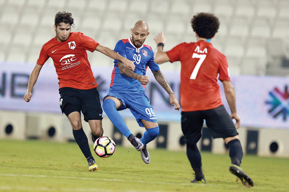 Al Shahaniya's Edu Eduardo Santos (centre) vies for the ball possession against two Al Rayyan players during their Qatar Stars League game at the Jassim Bin Hamad Stadium in this August 17 file photo.