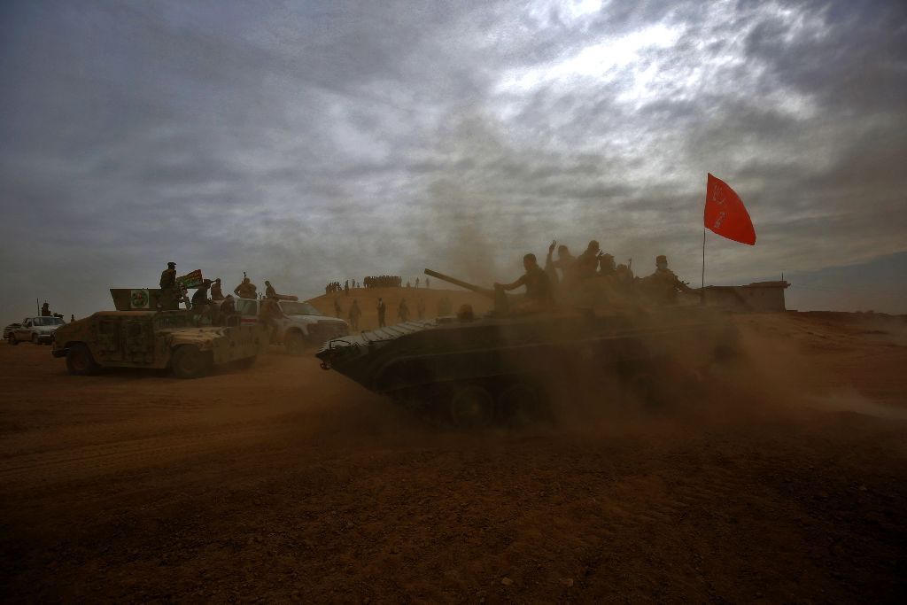 Shiite fighters from the Hashed al-Shaabi (Popular Mobilisation Units) enter the village of Abu Shuwayhah, south of jihadist-held Mosul, on November 1, 2016, during the ongoing operation to retake the last major Islamic State (IS) group stronghold in Iraq