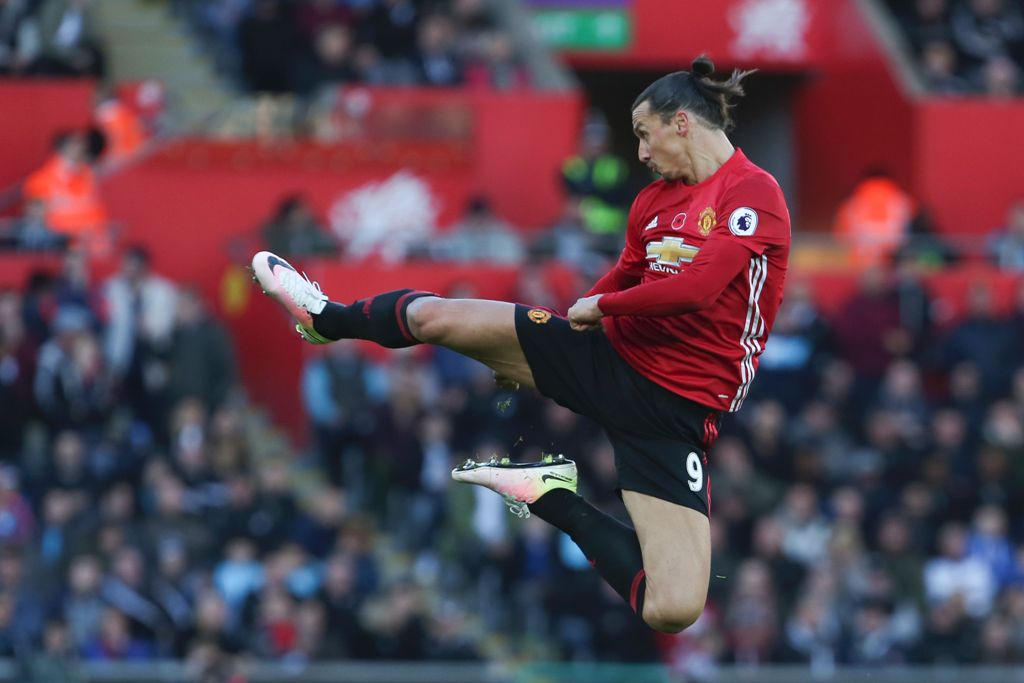 Manchester United's Swedish striker Zlatan Ibrahimovic jumps and kicks the air as he celebrates scoring his team's second goal during the English Premier League football match between Swansea City and Manchester United at The Liberty Stadium in Swansea, s