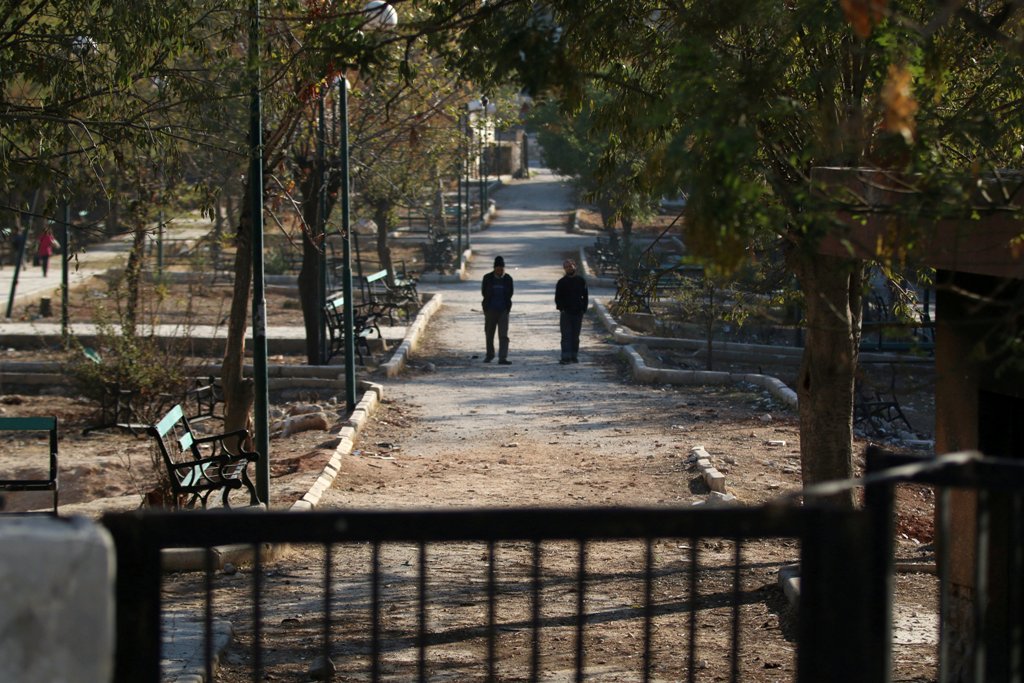 Men walk in a public park in a rebel-held besieged area in Aleppo, Syria November 6, 2016. REUTERS/Abdalrhman Ismail
