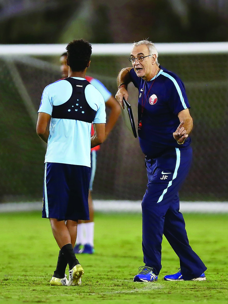 Qatar football players take part in a training session ahead of their friendly match against 2018 World Cup hosts Russia which will be played on Thursday in Doha. RIGHT: Head coach Jorge Fossati giving instructions to a player. The team will fly out to Ch