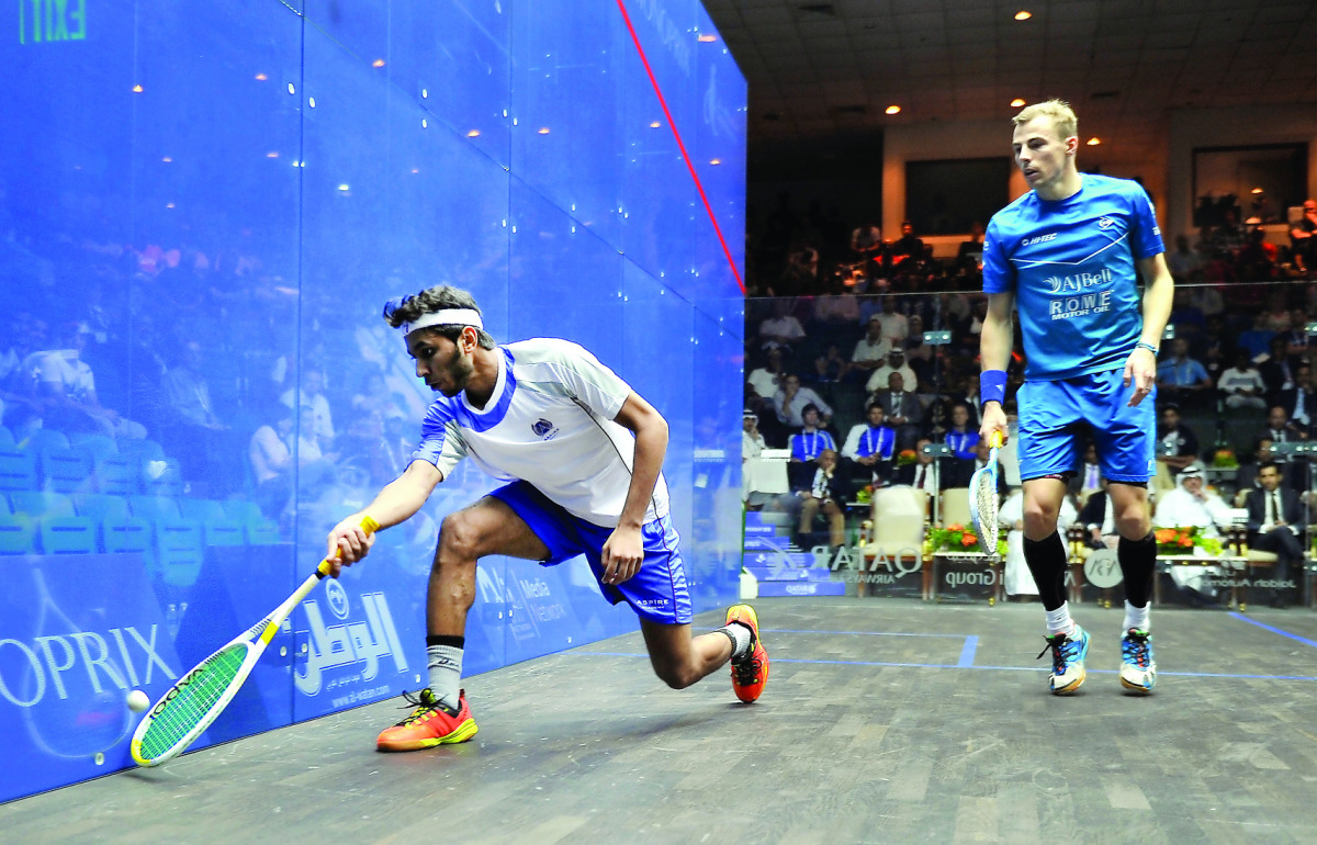 Abdulla Mohd Al Tamimi of Qatar (left) in action against Nick Matthew of England in Qatar Classic squash championship in Doha yesterday. Pics by: Abdul Basit/The Peninsula
