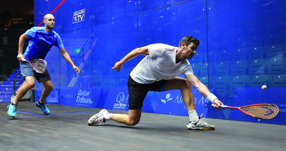 Adrian Waller from England in action with Nicolas Muller from Switzerland during the Qatar Classic 2016 in Doha yesterday. Pic by Kammutty VP/The Peninsula
