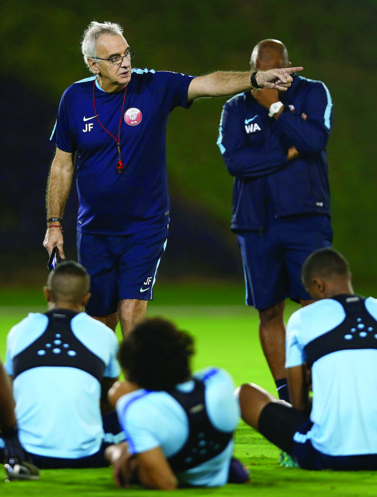 Qatar coach Jorge Fossati guides his team during a team training session. RIGHT: Qatar football players attend a training session ahead of their 2018 FIFA World Cup qualifying game against China today.