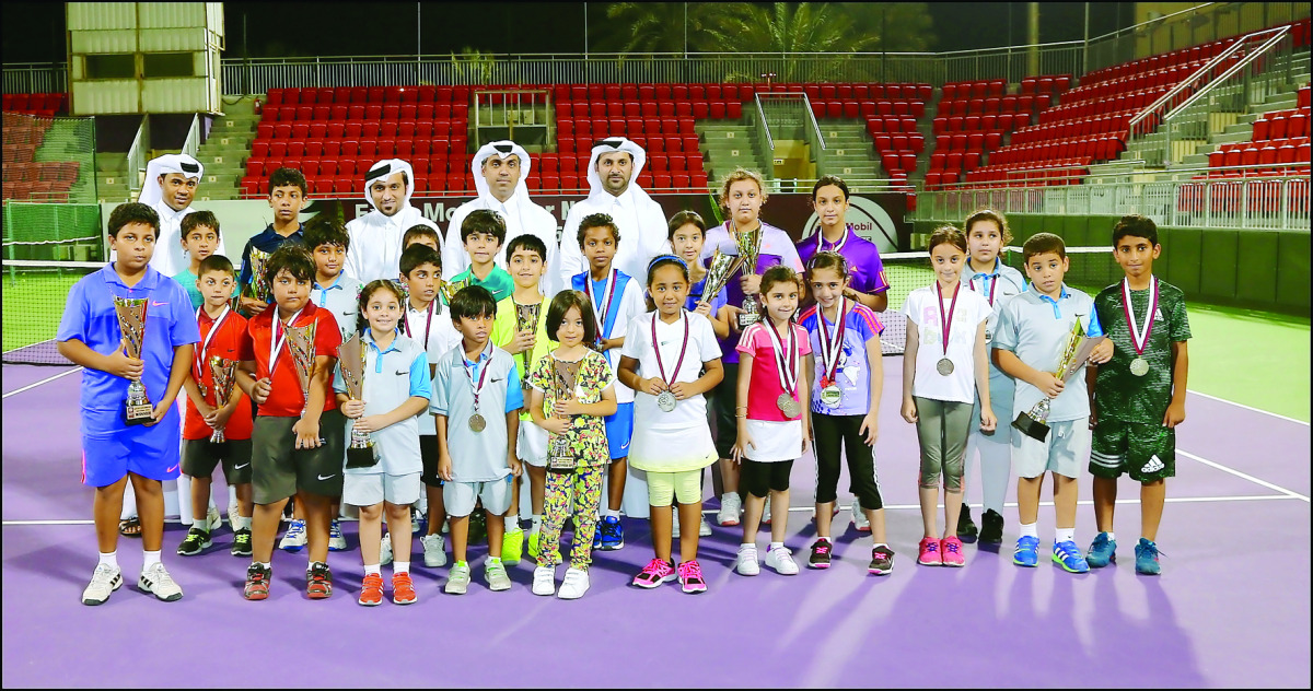Officials representing the Qatar Tennis Federation (QTF) and ExxonMobil Qatar taking a picture with young participants in the 2016 Qatar ExxonMobil Junior Open, at the Khalifa Tennis and Squash Complex, in Doha on Monday. 
