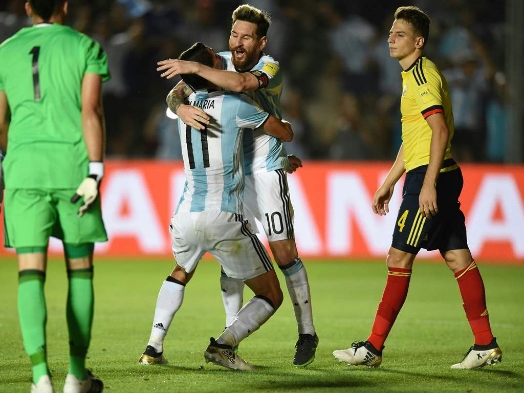 Argentina's Angel Di Maria celebrates with Argentina's Lionel Messi after scoring against Colombia during their 2018 FIFA World Cup qualifier football match in San Juan, Argentina, on November 15, 2016. / AFP / EITAN ABRAMOVICH