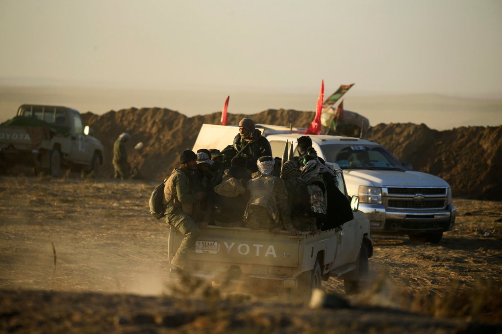 Military vehicle of Shi'ite fighters drive during a battle with Islamic State militants at the airport of Tal Afar west of Mosul, Iraq November 18, 2016. REUTERS/Thaier Al-Sudani