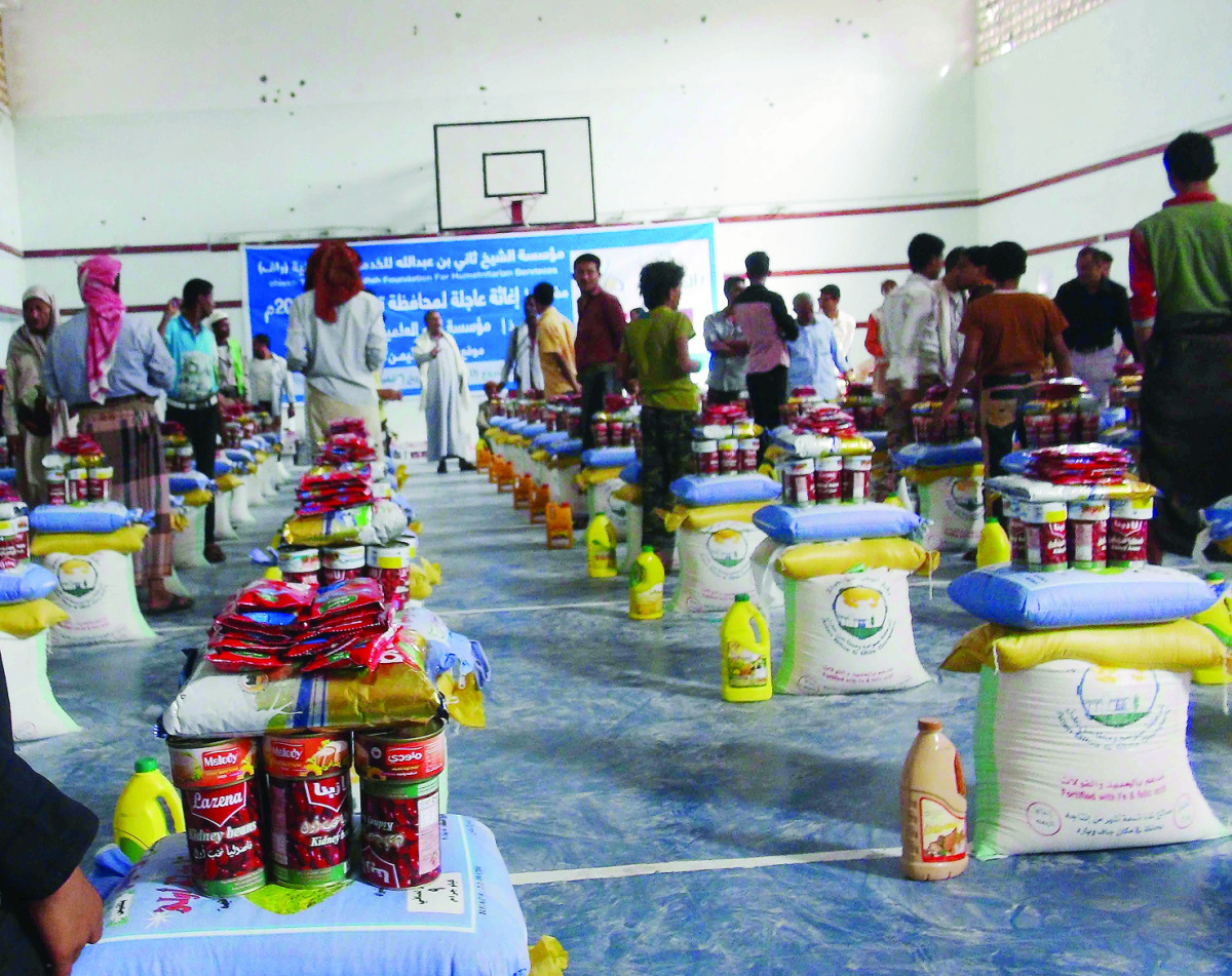 People receiving aid at a distribution point set up by RAF in Taiz, a besieged city of Yemen.