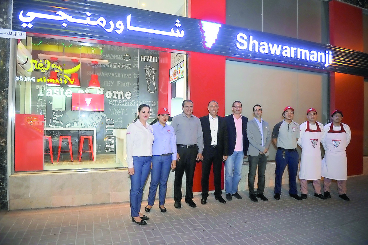 Camille E Aoun (centre), CEO of Shawarmanji, Georges Chamassian, General Manager of Al Mazak and the staff, in front of the outlet.