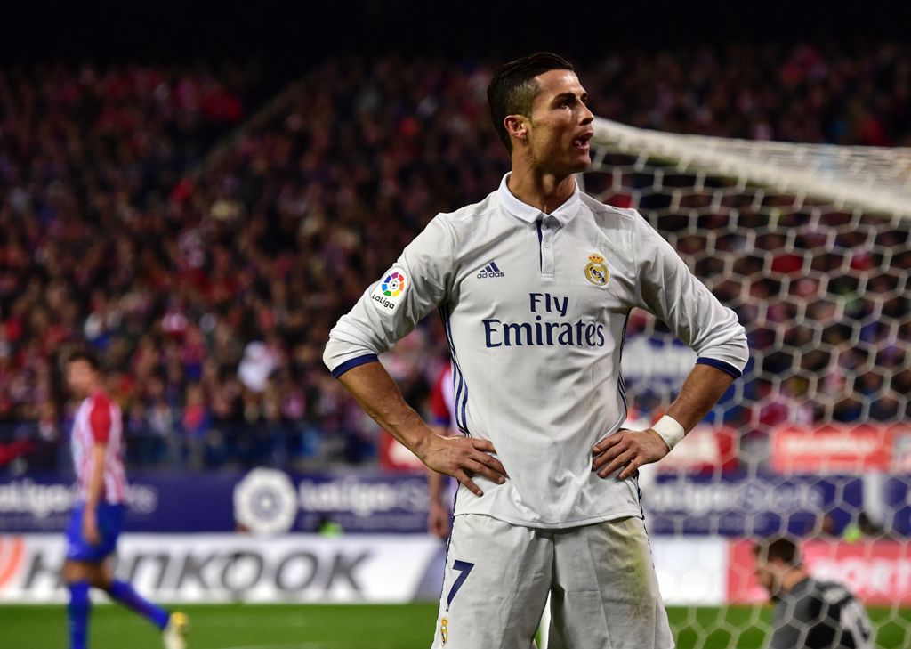Real Madrid's Portuguese forward Cristiano Ronaldo celebrates after scoring his third goal during the Spanish league football match Club Atletico de Madrid vs Real Madrid CF at the Vicente Calderon stadium in Madrid, on November 19, 2016. / AFP / GERARD J