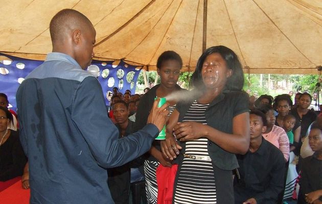 Lethebo Rabalago sprays Doom on a congregant at Mount Zion General Assembly (Photo courtesy: heraldlive.co.za)