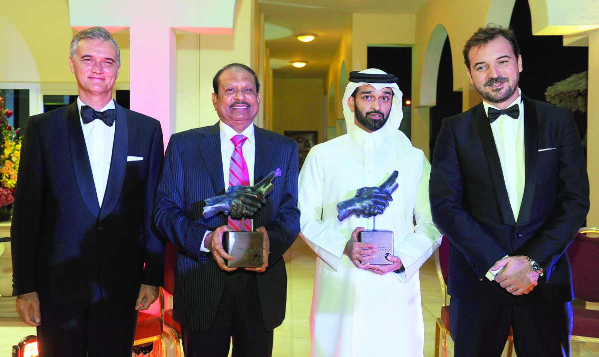 Managing Director of Lulu Group, Yusuffali M A (second left) and  Secretary-General of Supreme Committee for Delivery and Legacy, Hassan Al Thawadi (third left), after receiving the SDCL Award from the Ambassador of Spain to Qatar, Ignacio Escobar (left) 