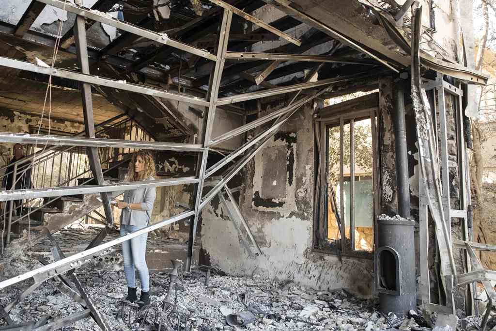 Really Golan inspects the damage at her house, which burned during a wildfire caused by dry conditions, on November 23, 2016 in the northern Israeli town of Zikhron Ya'aqov. In Zikhron Ya'aqov, more than ten homes were burnt and several people have been l