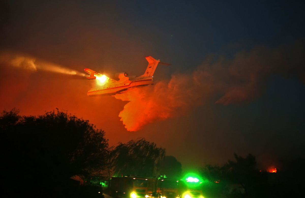 A Russian firefighter plane helps extinguish a new fire that broke out in the Israeli town of Nataf, west of the Arab Israeli town of Abu Ghosh, along the border with the occupied West Bank on November 25, 2016. Foreign firefighting planes helped Israel t