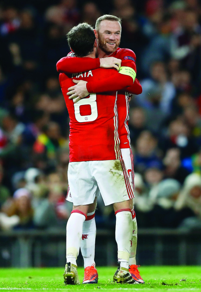 Manchester United's Wayne Rooney celebrates with Juan Mata after scoring a goal against Feyenoord during their UEFA Europa League match at Old Trafford in Manchester, England on Thursday.