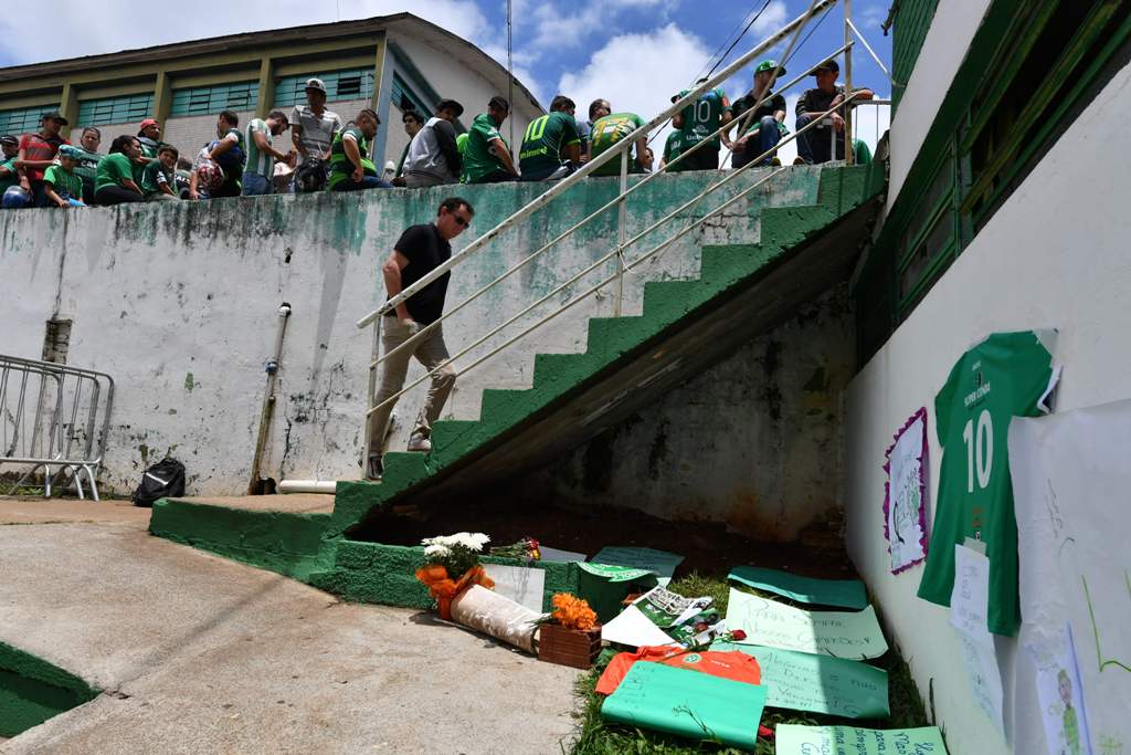 People pay tribute to the players of Brazilian team Chapecoense Real who were killed in a plane accident in the Colombian mountains, at the club's Arena Conda stadium in Chapeco, in the southern Brazilian state of Santa Catarina, on November 29, 2016.  AF